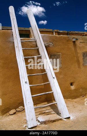 USA. New Mexico. Laguna. Pueblo architecture. Rustic ladder propped against mud wall. Stock Photo