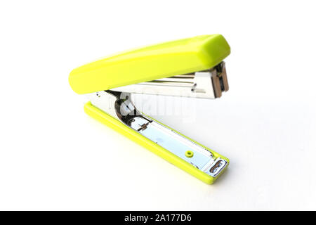 Green stapler on white background. Office supplies and stationary for binding papers. Stock Photo