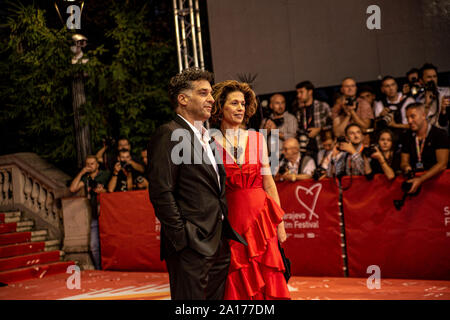 Bosnian film director Danis Tanovic and his wife Maelys de Rudder pose for photos on the red carpet during the 25th Sarajevo Film Festival opening event at the National Theatre, Susan Sontag Square. Stock Photo