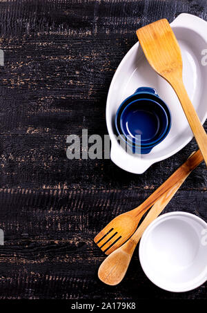 Kitchen utensils, cotton white checkered napkin on old wooden background. Selective focus. Stock Photo