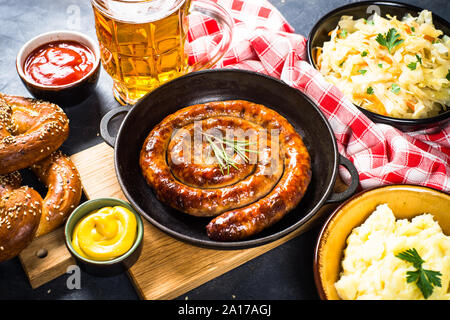 Oktoberfest food - sausage, beer and bretzel. Stock Photo