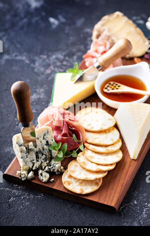 Cheese and snack board with crackers and prosciutto Stock Photo