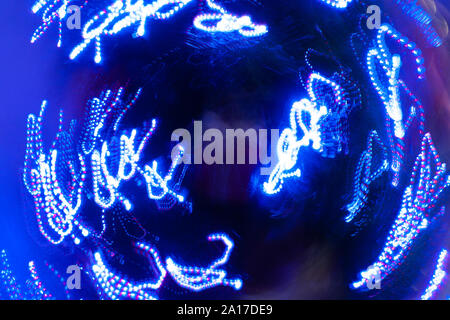 Intentional camera movement with blue fairy lights around a Christmas bauble Stock Photo
