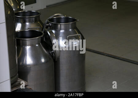 Empty milk flasks stand on the farm Stock Photo
