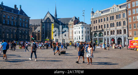 Dam Square with the Nieuwe Kerk (New Church), crowded with sightseeing tourists in summer. Amsterdam, The Netherlands. Stock Photo