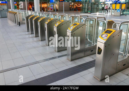 Train station ticket barriers gate across train platform big bold green ...