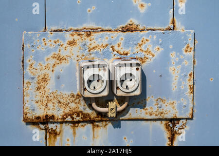 Two Old Rusty Electric Wall Sockets Stock Photo