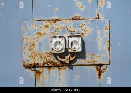 Two Old Rusty Electric Wall Sockets Stock Photo