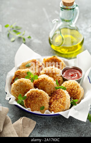 Chicken patties or fish cakes fried in breadcrumbs with ketchup Stock Photo