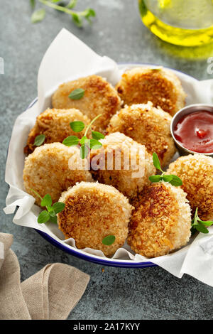 Chicken patties or fish cakes fried in breadcrumbs with ketchup Stock Photo