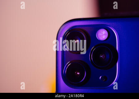 Paris, France - Sep 20, 2019: Blue color cast over new triple-lens Ultra-Wide, Wide, and Telephoto on the new latest Apple Computers iPhone 11 Pro and 11 Pro Max smartphone Stock Photo