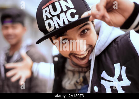 Young  playful guy wearing hip hop cap and sports clothing Stock Photo