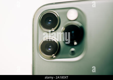 Paris, France - Sep 20, 2019: Detailed close-up macro details of new latest Apple Computers iPhone 11 Pro and 11 Pro Max smartphone triple-lens camera and new technology - Midnight green color Stock Photo