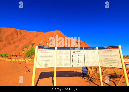 Uluru, Northern Territory, Australia - Aug 23, 2019: warning signs at Mala Parking. Please do not climb Uluru sign.Uluru is sacred to Anangu people Stock Photo