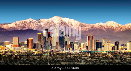 Los Angeles skyline with snow capped mountains Stock Photo