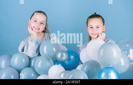 Happiness and cheerful moments. Carefree childhood. Sisters organize home party. Having fun concept. Balloon theme party. Girls best friends near air balloons. Start this party. Birthday party. Stock Photo