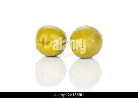 Group of two whole pitted green olive isolated on white background Stock Photo