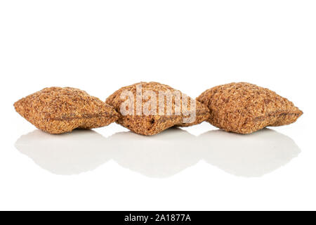Group of three whole crispy brown cereal pillow isolated on white background Stock Photo
