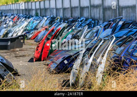 Spare parts. Many car doors for aftermarket for shop auto service. Stock Photo