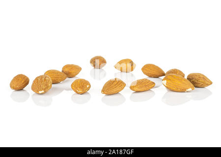 Lot of whole brown almond nut triangle isolated on white background Stock Photo