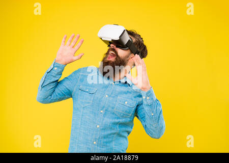 Impressive visual effects. Bearded man explore vr. Gamer concept. Gaming hobby. Cyber sport. Augmented reality. Game development. Digital technology. Living alternative life. Hipster play video game. Stock Photo