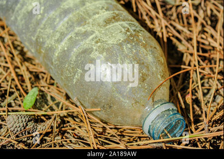 Discarded water bottle laying the ground Stock Photo