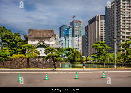 Tradition and Modernity in Japan. View of Imperial Palace old tower with the modern buildings side by side in central Tokyo Stock Photo