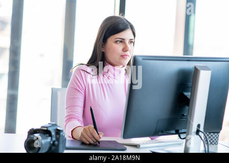 Woman hand drawing with graphics tablet, working designer Stock Photo