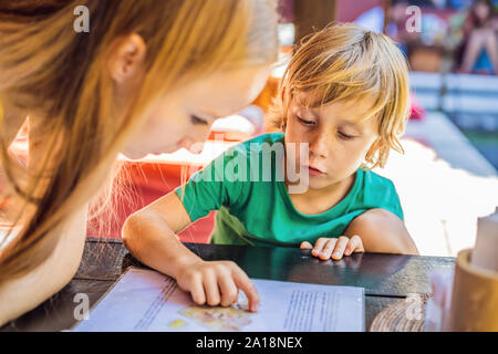 Mother with her son looking at menu in restaurant Stock Photo