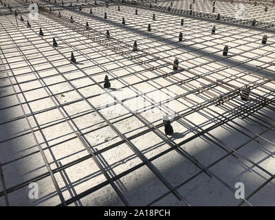 Metal reinforcement grid with plastic holders. Reinforced concrete preparation. Concrete basement construction. Stock Photo