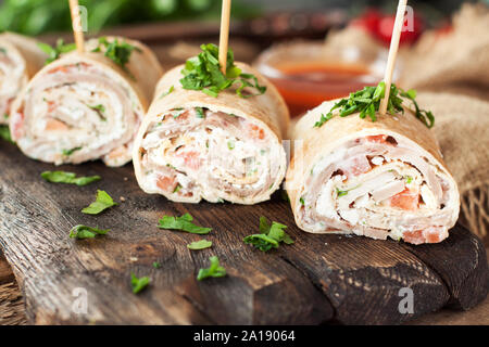 Taco bites with turkey or chicken, cheese, vegetables and fresh herbs. Healthy appetizer rolls Stock Photo