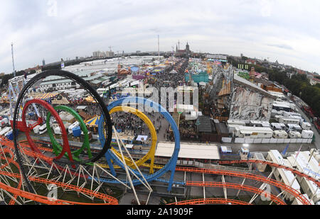 24 September 2019, Bavaria, Munich: Oktoberfest 2019, The Oktoberfest with the Paulskirche can be seen from the Loopingachterbahn. The largest folk festival in the world lasts until 6 October. Photo: Felix Hörhager/dpa Stock Photo