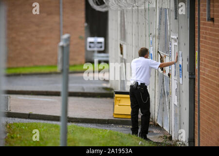 A general view of an officer next to a gate at HMP Long Lartin, near Worcester, where order has been restored after a siege at the prison last night, when a group of inmates took over part of a building, the Ministry of Justice said. Stock Photo