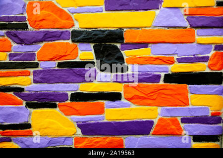 Multicolor violet and orange  brick wall close up Stock Photo