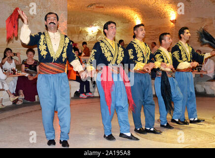 Avanos / Turkey - April 25, 2013: Traditional Turkish dancers dance for tourists in a local restaurant Stock Photo