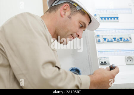 male hand switching on fuse board Stock Photo