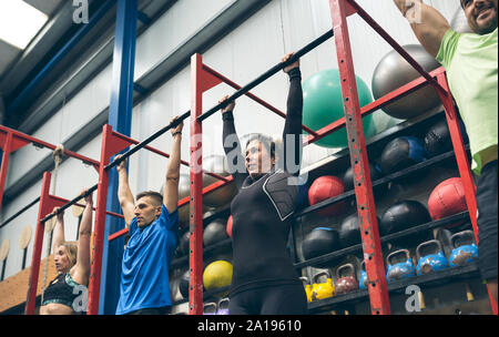 Athletes ready to do pull ups in the box Stock Photo