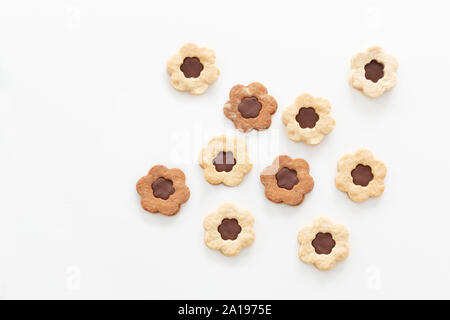 Homemade shortbread cookies layered with milk chocolate, lie on a white table. Stock Photo
