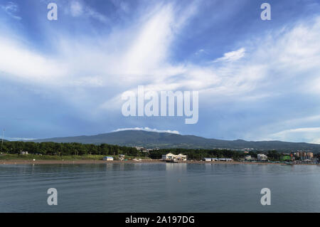 Majestic cloudscape over hallasan mountain and Jeju island with view on  iho tewoo beach Stock Photo