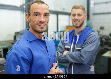 portrait of engineer and colleague in workshop Stock Photo