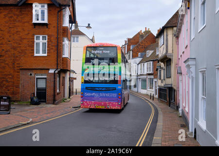 Doubledecker Bus going through the narrow streets of Lewes, East Sussex. Bus painted in Pride colours, celebrating diversity in Brighton and Hove Stock Photo