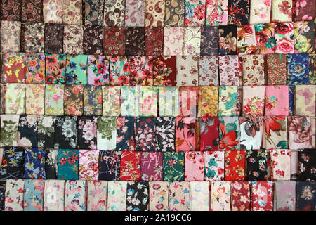 floral fabric scarf laid out in rows street vendor Stock Photo