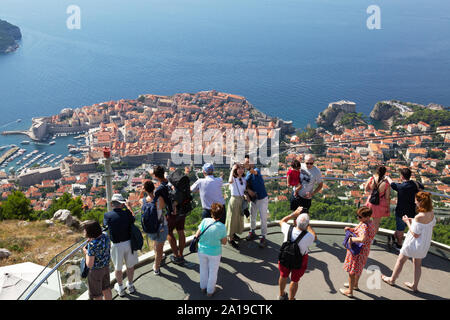 Dubrovnik tourists - people at the panorama viewpoint at the top of the Dubrovnik cable car on Mount Srd looking down at Dubrovnik old town, Croatia Stock Photo