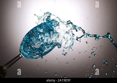 Stylised,colourful image of liquid splashing into wine glass Stock Photo