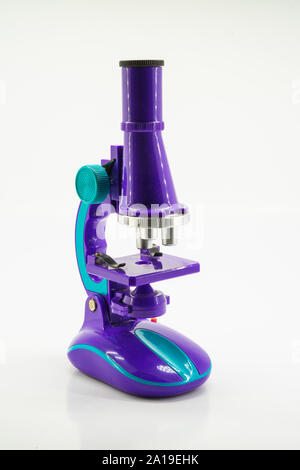 Purple microscope isolated on white. Stock Photo