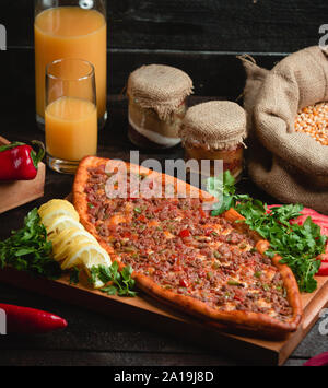 Turkish meat pide with slices of lemon and herbs Stock Photo