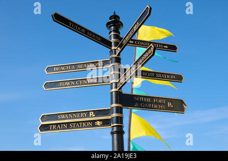 A traditional fingerpost sign in a town with directions for local amenities and attractions, Weymouth, Dorset, England, UK Stock Photo