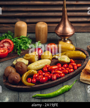 Variety of pickles on wooden dishes Stock Photo