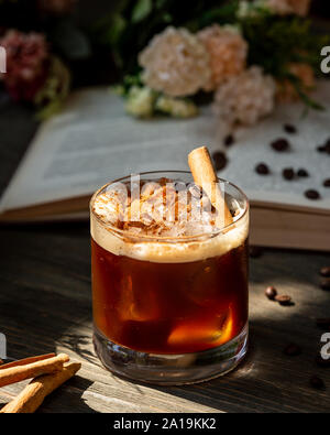 Whiskey with cinnamon on the table Stock Photo