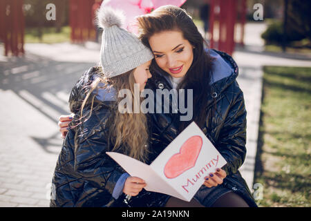 Cute and stylish family in a spring park Stock Photo